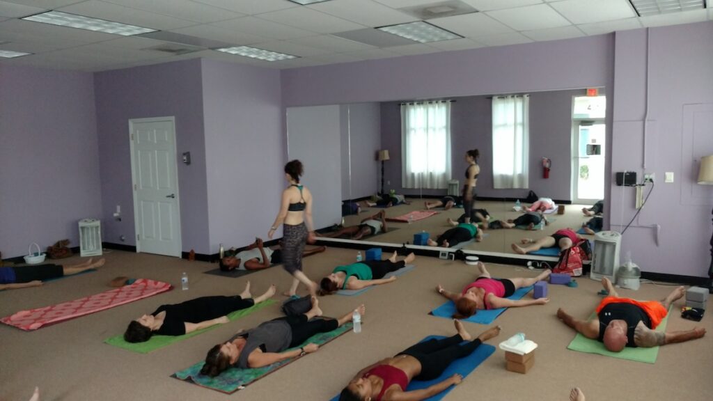 Teaching a group yoga class in a studio