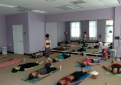 Teaching a group yoga class in a studio